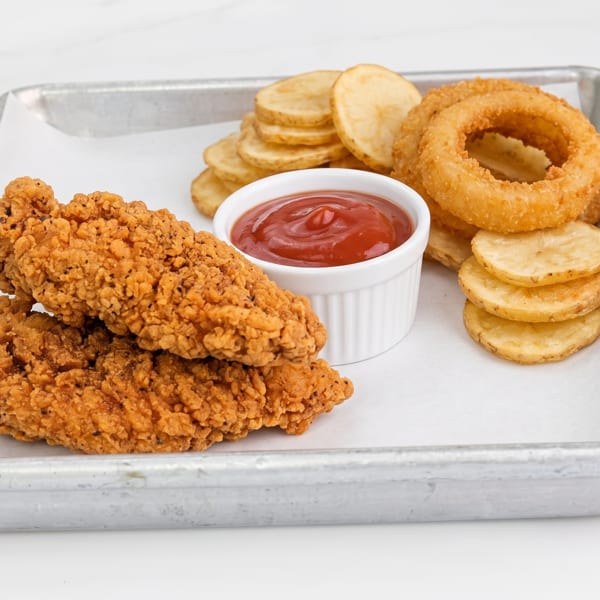Crispy chicken tenders, golden onion rings, and potato chips with ketchup on a metal tray.
